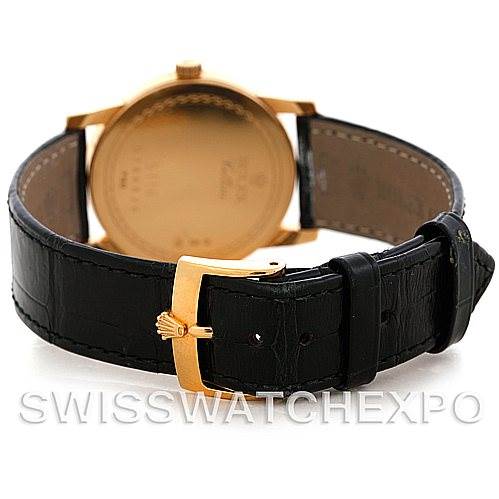 This image shows the back view of a Rolex Cellini 5116 Men's Yellow Gold Champagne Dial 5116 Men's Yellow Gold Champagne Dial watch, highlighting its leather strap and golden clasp with the Rolex logo.