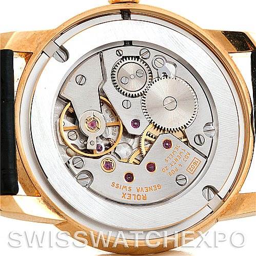 The image shows the inner mechanism of the Rolex Cellini 5116 Men's Yellow Gold Champagne Dial 5116 Men's Yellow Gold Champagne Dial watch from a rear angle, highlighting the gears and movement.