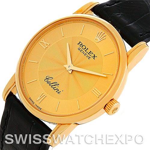 The image shows a Rolex Cellini 5116 Men's Yellow Gold Champagne Dial 5116 Men's Yellow Gold Champagne Dial watch from an angular top view, highlighting the gold case, dial, and black leather strap.