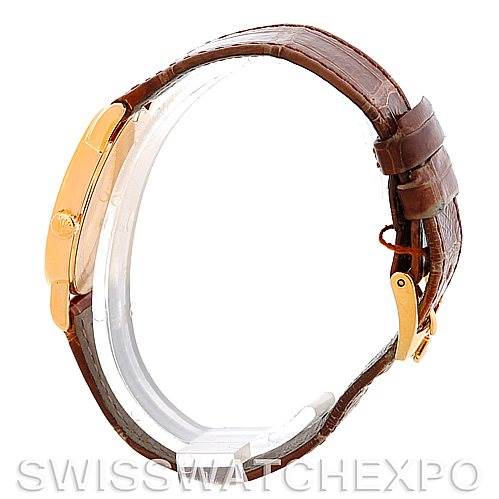 This side view of the Rolex Cellini 5115 Men's Yellow Gold Silver Dial 5115 Men's Yellow Gold Silver Dial watch shows the strap, buckle, and case.