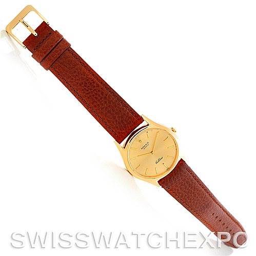 The image shows a Rolex Cellini 3804 Men's Yellow Gold Champagne Dial 3804 Men's Yellow Gold Champagne Dial watch at a top-down angle, highlighting its brown leather strap and gold-toned round dial.