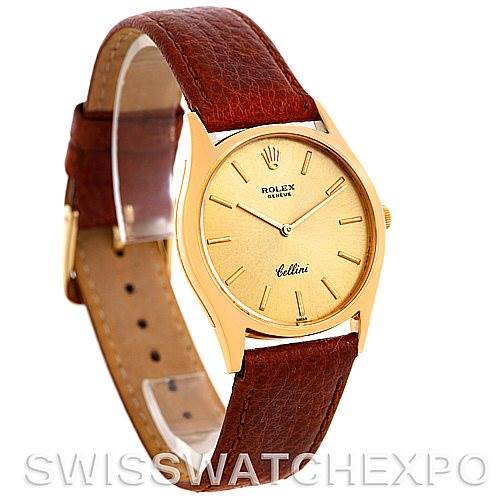 The image shows a side front angle of a Rolex Cellini 3804 Men's Yellow Gold Champagne Dial 3804 Men's Yellow Gold Champagne Dial watch with a brown leather strap and a gold dial.