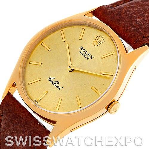 This image shows a close-up angle of a Rolex Cellini 3804 Men's Yellow Gold Champagne Dial 3804 Men's Yellow Gold Champagne Dial watch, highlighting its golden dial, crown, and brown leather strap.