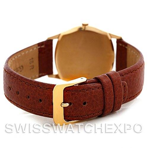 The image shows the back view of a Rolex Cellini 3804 Men's Yellow Gold Champagne Dial 3804 Men's Yellow Gold Champagne Dial watch, featuring the case back and the brown leather strap with a gold buckle.