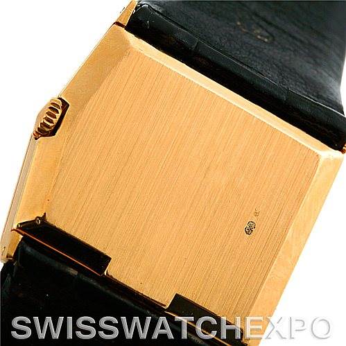This image shows the rectangular back case and part of the leather strap of the Rolex Cellini Men's Yellow Gold Black Dial Men's Yellow Gold Black Dial watch.