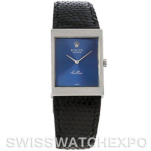 The image shows a frontal view of the Rolex Cellini 4014 Men
s White Gold Blue Dial 4014 Men
s White Gold Blue Dial watch with a blue dial, rectangular case, and black patterned strap.