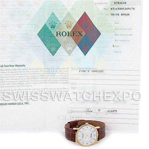The image shows a Rolex Cellini 5115 Men's Yellow Gold Silver Dial 5115 Men's Yellow Gold Silver Dial model watch set at an angle on its side with a warranty document in the background.