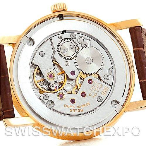 The image shows the open case back of a Rolex Cellini 5115 Men's Yellow Gold Silver Dial 5115 Men's Yellow Gold Silver Dial watch, revealing its intricate mechanical movement.