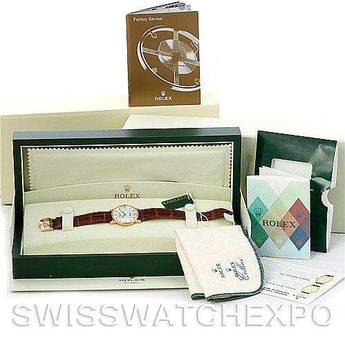The image shows a Rolex Cellini 5115 Men's Yellow Gold Silver Dial 5115 Men's Yellow Gold Silver Dial watch from a front angle, along with its box, warranty card, service booklet, and other accessories.