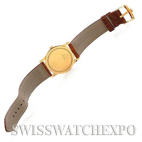 This image shows the back of a Rolex Cellini 5116 Men
s Yellow Gold Champagne Dial 5116 Men
s Yellow Gold Champagne Dial watch, highlighting its leather strap and gold buckle.