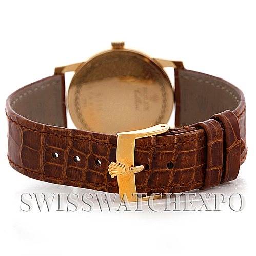 The image shows the back of a Rolex Cellini 5116 Men
s Yellow Gold Champagne Dial 5116 Men
s Yellow Gold Champagne Dial watch, focusing on the leather strap and gold buckle.