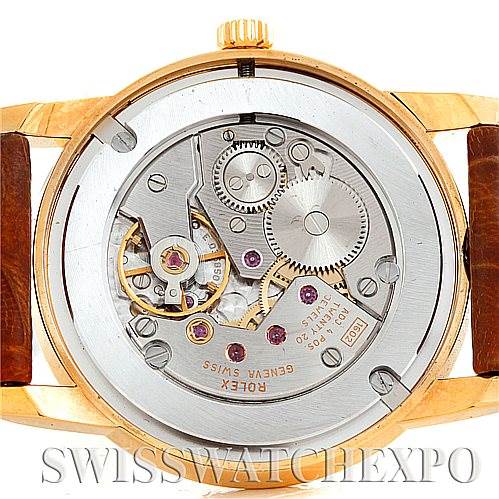 The image shows the back view of a Rolex Cellini 5116 Men
s Yellow Gold Champagne Dial 5116 Men
s Yellow Gold Champagne Dial watch, highlighting its internal movement and mechanics.