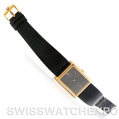 This image shows a top view of a Rolex Cellini 4105 Men's Yellow Gold Black Dial 4105 Men's Yellow Gold Black Dial watch, displaying its rectangular face, black strap, and golden buckle.