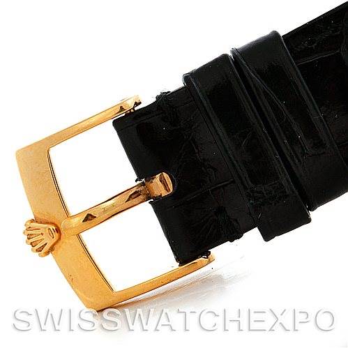 This is a close-up of a Rolex Cellini 5115 Men's Yellow Gold Beige Dial 5115 Men's Yellow Gold Beige Dial watch strap buckle, showcasing the gold-tone clasp and black leather strap.