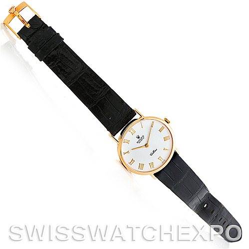 The Rolex Cellini 5112 Men
s Yellow Gold White Dial 5112 Men
s Yellow Gold White Dial watch is shown at a top-down angle, displaying the entire timepiece, including the face, strap, and clasp.