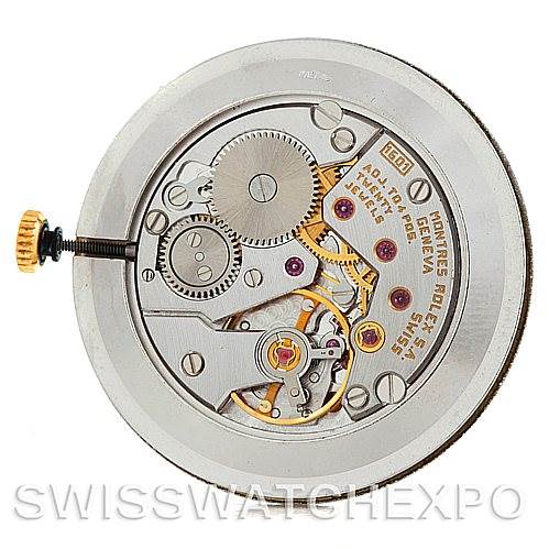 The image shows an internal view of the Cellini model by Rolex, highlighting the intricate gears and mechanical parts of the watch movement.
