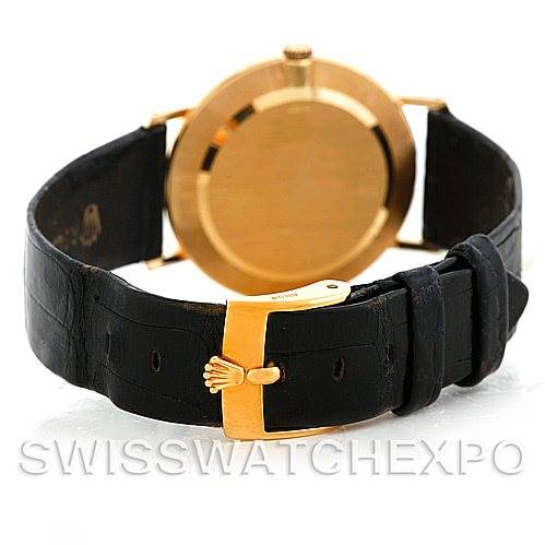 This image shows the back case and clasp of a Rolex Cellini 5112 Men
s Yellow Gold White Dial 5112 Men
s Yellow Gold White Dial watch, featuring a black leather strap and gold-toned buckle.