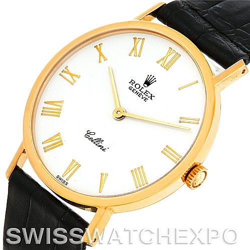 The Rolex Cellini 5112 Men
s Yellow Gold White Dial 5112 Men
s Yellow Gold White Dial watch is shown at a slight angle, highlighting its gold case, white dial with Roman numerals, and black leather strap.