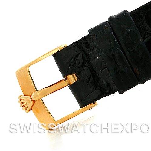 The image shows a close-up of the buckle and part of the black leather strap of a Rolex Cellini 5112 Men
s Yellow Gold White Dial 5112 Men
s Yellow Gold White Dial watch.