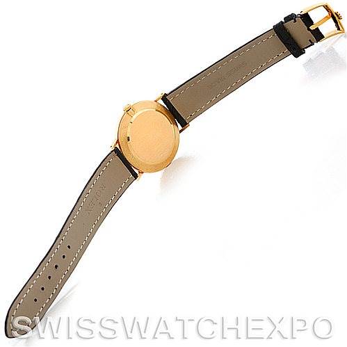The image shows the back and straps of a Rolex Cellini 4112 Men's Yellow Gold White Dial 4112 Men's Yellow Gold White Dial watch from a top-down angle.