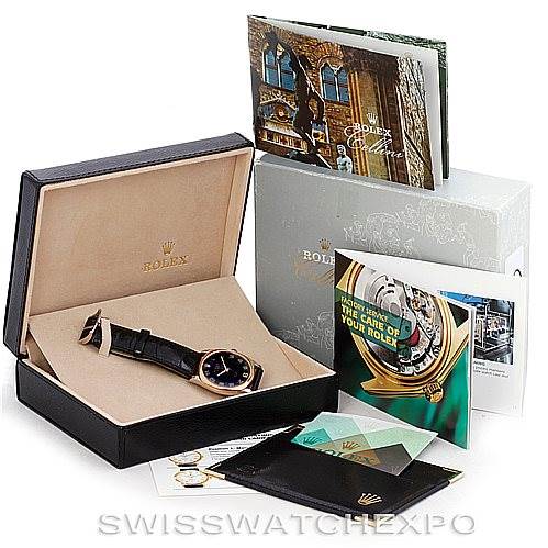The image shows a Rolex Cellini 4233 Men's White Gold Black Dial 4233 Men's White Gold Black Dial watch at an angle inside its box, along with documentation and accessories.