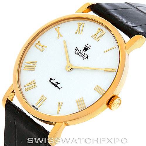 The image shows a close-up of a Rolex Cellini 5112 Men's Yellow Gold White Dial 5112 Men's Yellow Gold White Dial watch, featuring its white dial, golden Roman numerals, and black leather strap.