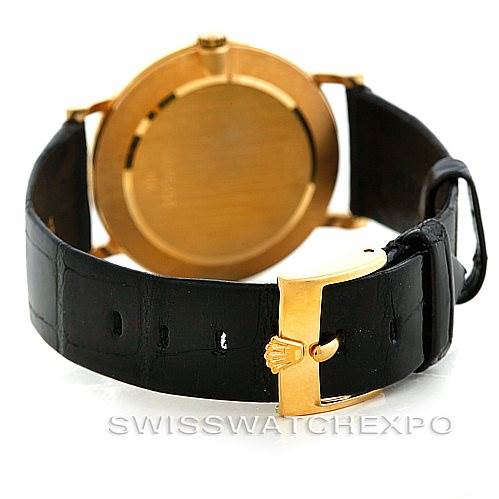 The image shows the rear view of a Rolex Cellini 5112 Men's Yellow Gold White Dial 5112 Men's Yellow Gold White Dial watch with a black leather strap and a gold clasp.