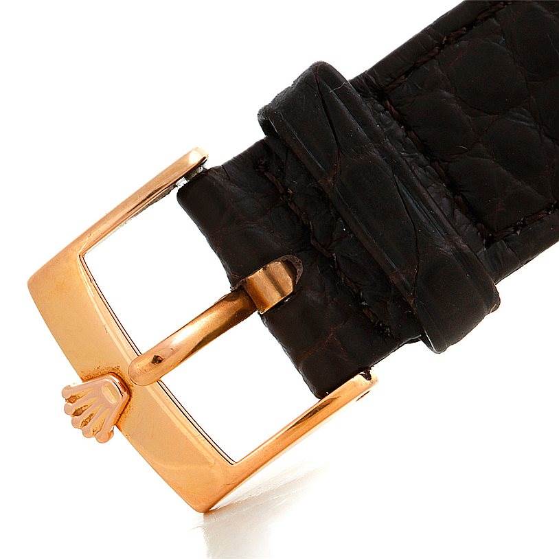 This image shows a close-up of the buckle and strap of a Rolex Cellini 5330 Men's Rose Gold Grey Dial 5330 Men's Rose Gold Grey Dial watch, highlighting its gold clasp and dark leather strap.