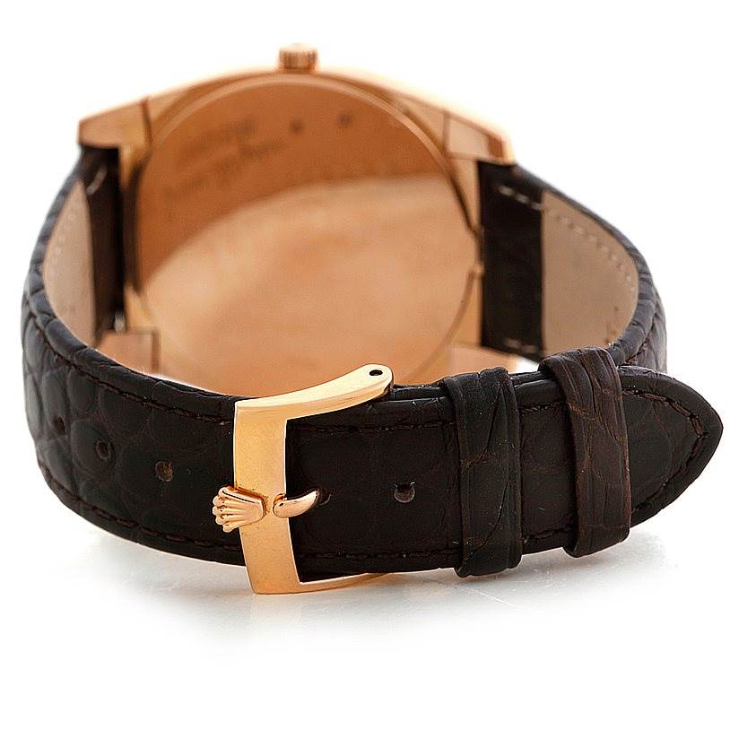 The image shows the back view of a Rolex Cellini 5330 Men's Rose Gold Grey Dial 5330 Men's Rose Gold Grey Dial watch, showcasing its clasp and leather strap.