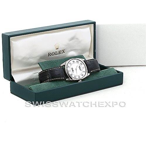 The Rolex Cellini 4233 Men's White Gold White Dial 4233 Men's White Gold White Dial watch is shown in an angled view, displaying its face, leather strap, and packaging box with the logo.