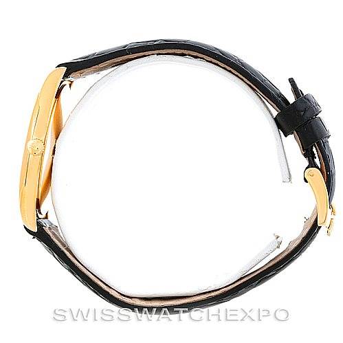 The image shows a side view of a Rolex Cellini 4233 Men's Yellow Gold Black Dial 4233 Men's Yellow Gold Black Dial watch, highlighting its gold case and black leather strap.