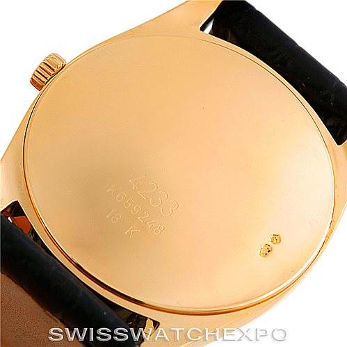 The image shows the back case of a Rolex Cellini 4233 Men's Yellow Gold Black Dial 4233 Men's Yellow Gold Black Dial watch with its engraved model and serial number.