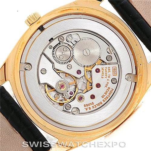 The image shows the movement of a Rolex Cellini 4233 Men's Yellow Gold Black Dial 4233 Men's Yellow Gold Black Dial watch from a rear angle, displaying the intricate internal mechanisms.