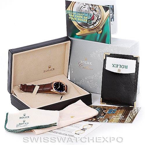 The image shows a Rolex Cellini 4233 Men's White Gold Black Dial 4233 Men's White Gold Black Dial watch in its box with accompanying accessories including booklets, a pouch, and cleaning cloths.