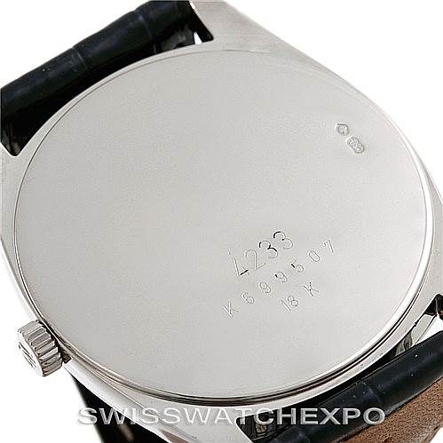 The image shows the back case of a Rolex Cellini 4233 Men's White Gold White Dial 4233 Men's White Gold White Dial watch, highlighting its engraved details and part of the black strap.