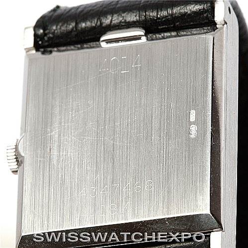 This image shows the back case of a Rolex Cellini 4014 Men
s White Gold Silver Dial 4014 Men
s White Gold Silver Dial watch along with part of its leather strap and crown.