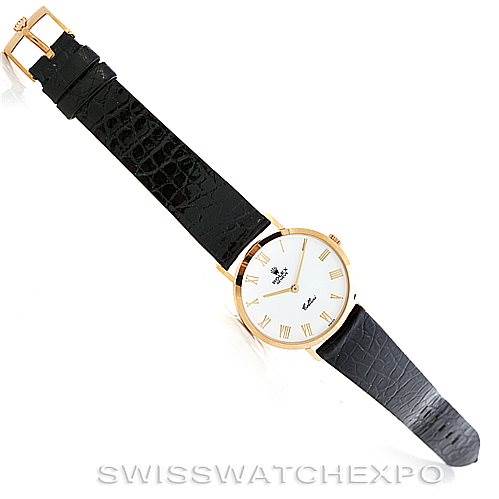 The image showcases a Rolex Cellini 4112 Men's Yellow Gold White Dial 4112 Men's Yellow Gold White Dial watch laid flat, displaying its black leather strap and gold-toned case from a top-down angle.