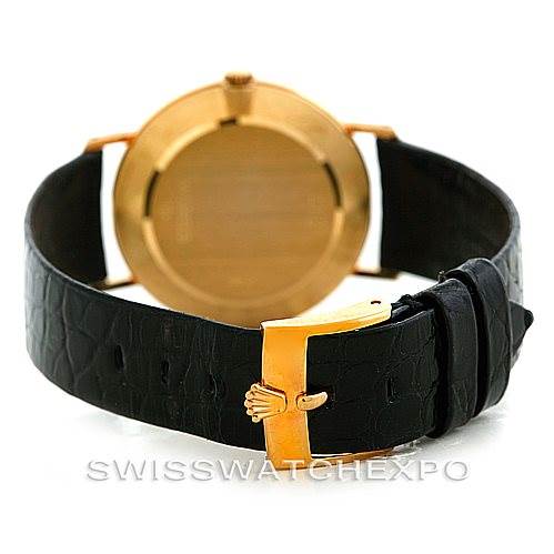 The image shows the back view of a Rolex Cellini 4112 Men's Yellow Gold White Dial 4112 Men's Yellow Gold White Dial watch, highlighting its gold case and black leather strap.