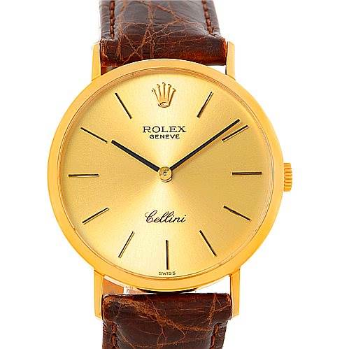 This image shows the face of the Rolex Cellini 4112 Men's Yellow Gold Champagne Dial 4112 Men's Yellow Gold Champagne Dial watch, highlighting its golden dial, black hands, and brown leather strap.