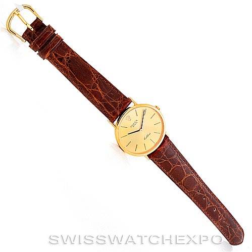 The Rolex Cellini 4112 Men's Yellow Gold Champagne Dial 4112 Men's Yellow Gold Champagne Dial watch is shown from a top-down angle, displaying its brown leather strap, gold watch face, and gold buckle.