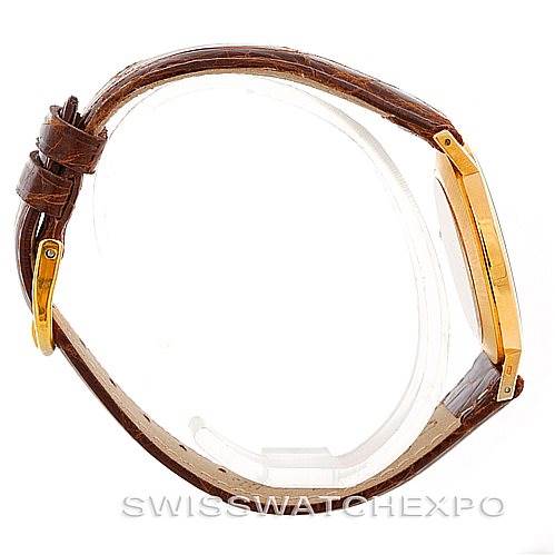 This side view of a Rolex Cellini 4112 Men's Yellow Gold Champagne Dial 4112 Men's Yellow Gold Champagne Dial watch showcases its brown leather strap and gold case.