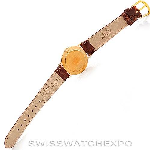 The Rolex Cellini 4112 Men's Yellow Gold Champagne Dial 4112 Men's Yellow Gold Champagne Dial watch is shown from the back at an overhead angle, displaying the leather strap and gold case back.