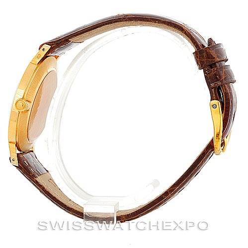 This image shows a side profile of a Rolex Cellini 4112 Men's Yellow Gold Champagne Dial 4112 Men's Yellow Gold Champagne Dial watch with a brown leather strap and a gold case.