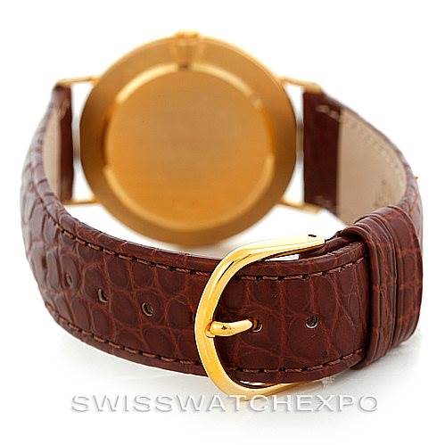 The image shows the back view of a Rolex Cellini 4112 Men's Yellow Gold Champagne Dial 4112 Men's Yellow Gold Champagne Dial watch, featuring its leather strap and golden clasp.