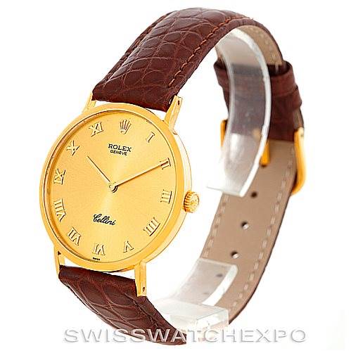 The image shows a Rolex Cellini 4112 Men's Yellow Gold Champagne Dial 4112 Men's Yellow Gold Champagne Dial watch at an angle showcasing its gold dial, Roman numeral markers, brown leather strap, and gold buckle.
