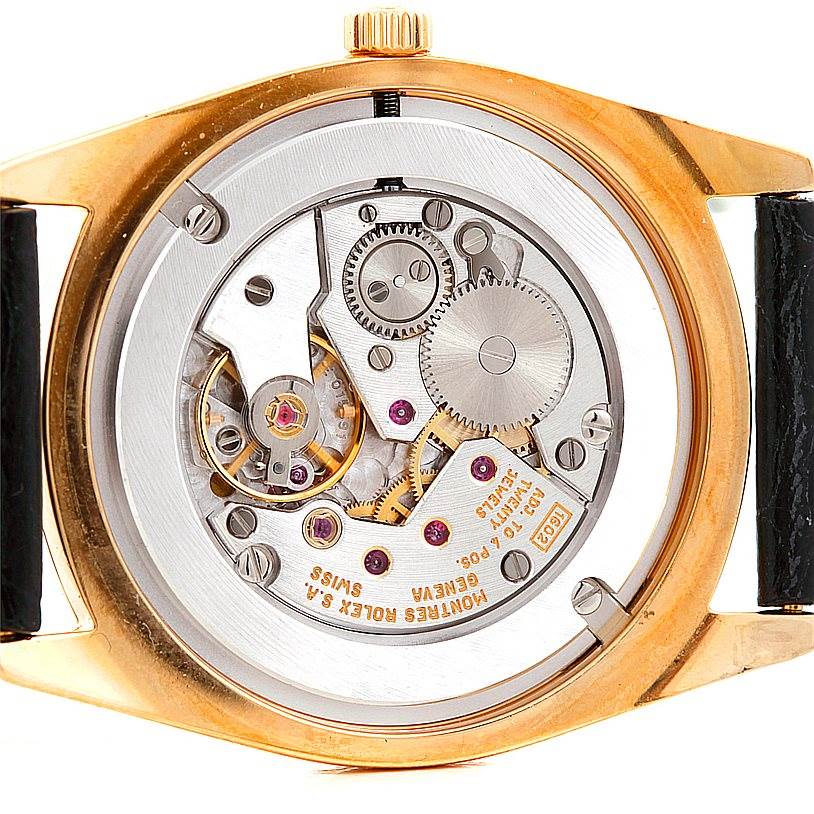 This is a back view of the Rolex Cellini 4233 Men's Yellow Gold White Dial 4233 Men's Yellow Gold White Dial watch showing its intricate mechanical movement and gears.
