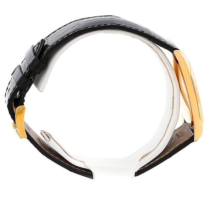 This image shows a side view of a Cellini model by Rolex, focusing on the black leather strap and the gold case.