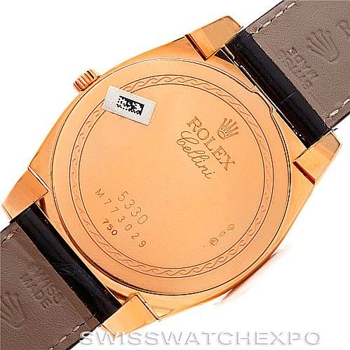 This image shows the back case of a Rolex Cellini 5330 Men's Rose Gold White Dial 5330 Men's Rose Gold White Dial watch with leather straps and engraved details on the case.