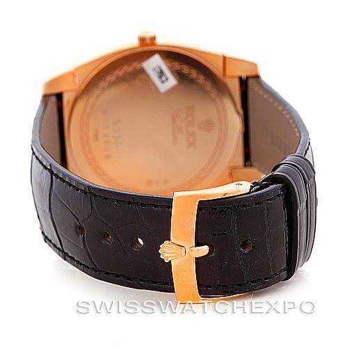 The image shows the back view of a Rolex Cellini 5330 Men's Rose Gold White Dial 5330 Men's Rose Gold White Dial watch with a focus on its leather strap and gold buckle.