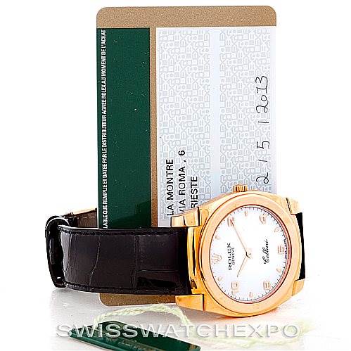 This image shows a Rolex Cellini 5330 Men's Rose Gold White Dial 5330 Men's Rose Gold White Dial watch with a leather strap and its warranty card positioned behind it.